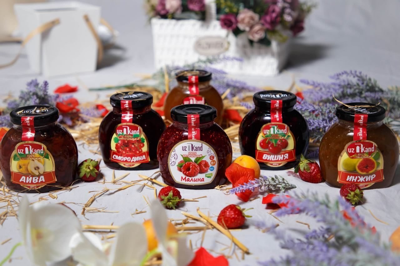 UzKand quince, fig and berry preserve jars on a table